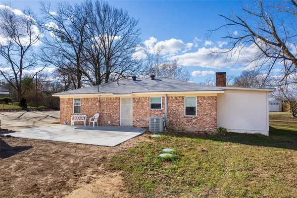 a view of a house next to a yard