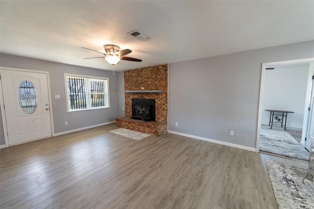 2339 Southwest County Road 3110 Mount Vernon, TX 75457 - Photo 8 of 31 an empty room with windows and fireplace