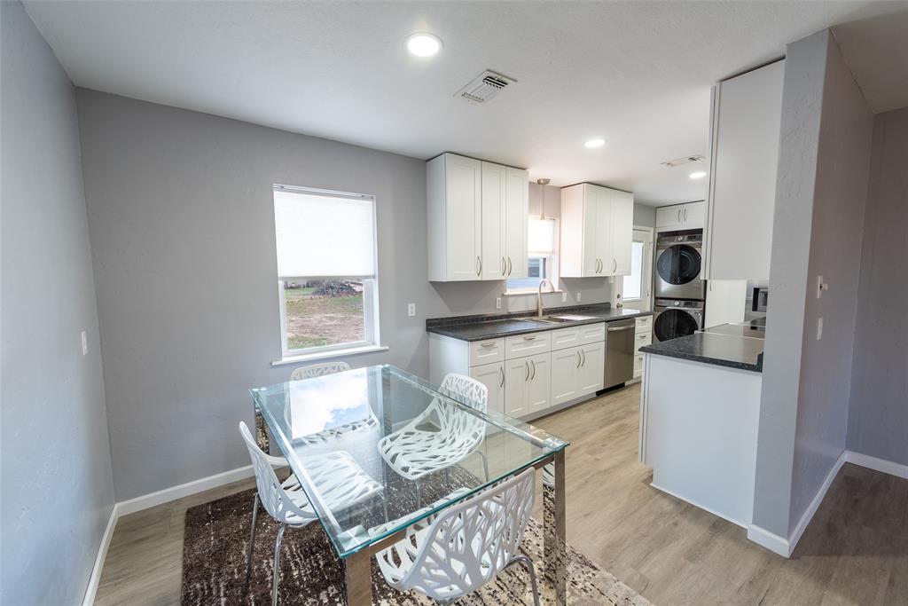 2339 Southwest County Road 3110 Mount Vernon, TX 75457 - Photo 10 of 31 a kitchen with stainless steel appliances kitchen island granite countertop a sink and a stove
