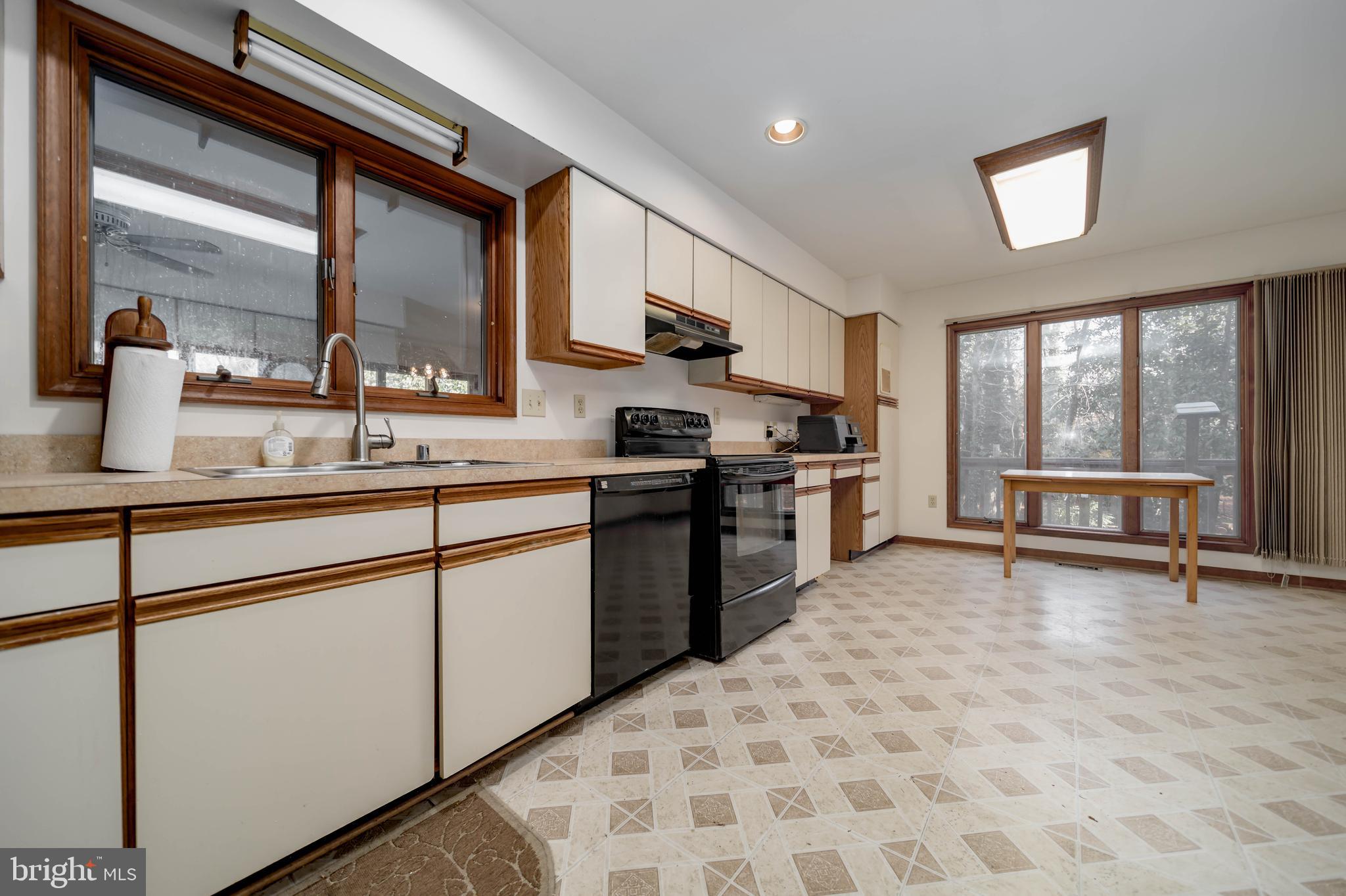 5510 Stephen Reid Road Huntingtown, MD 20639 - Photo 6 of 59 a kitchen with stainless steel appliances granite countertop a stove a sink and a microwave
