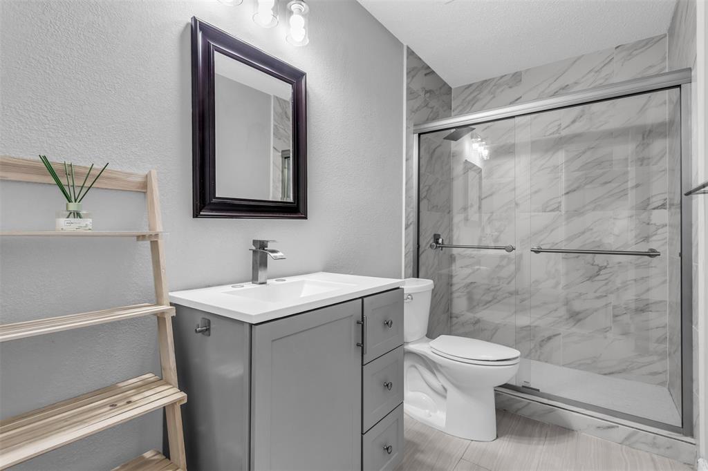 308 Glen Ridge Drive Murphy, TX 75094 - Photo 15 of 36 a bathroom with a sink vanity mirror and toilet