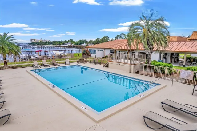 a view of a swimming pool with outdoor seating and city view