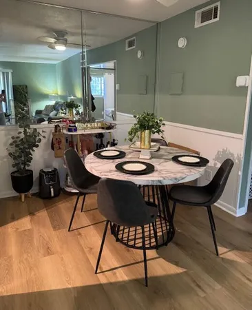 a view of a dining room with furniture and chandelier