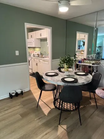 a view of a dining room with furniture and wooden floor