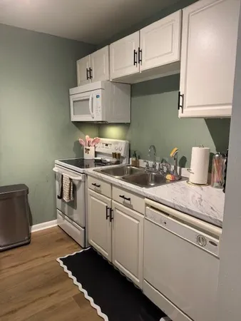 a white toilet sitting next to a bathroom sink