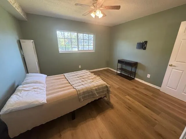 a bedroom with a bed and a window