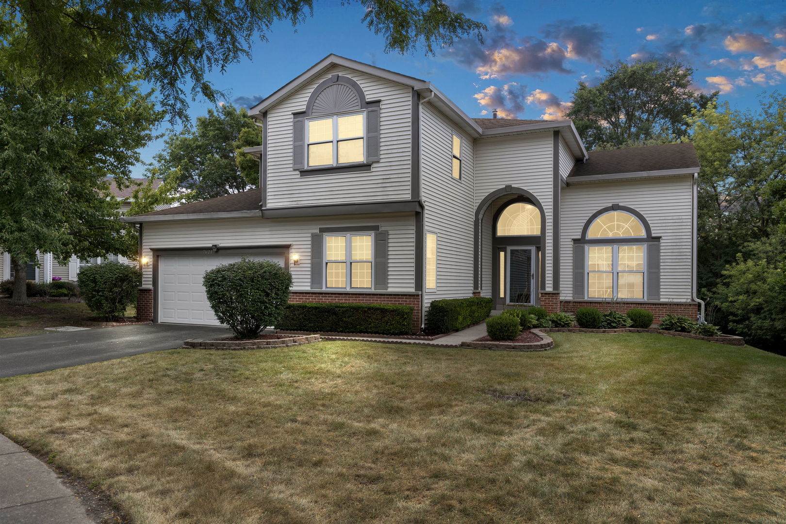 7623 Beringer Court Gurnee, IL 60031 - Photo 1 of 28 a front view of a house with garden