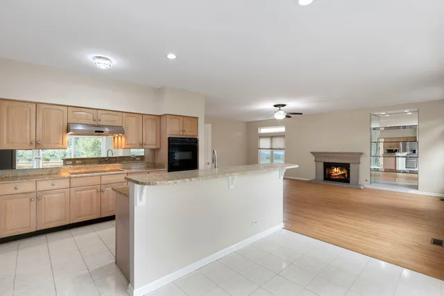 a large kitchen with kitchen island a sink stainless steel appliances and cabinets