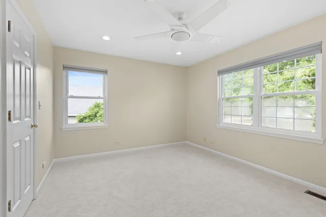 an empty room with windows and closet