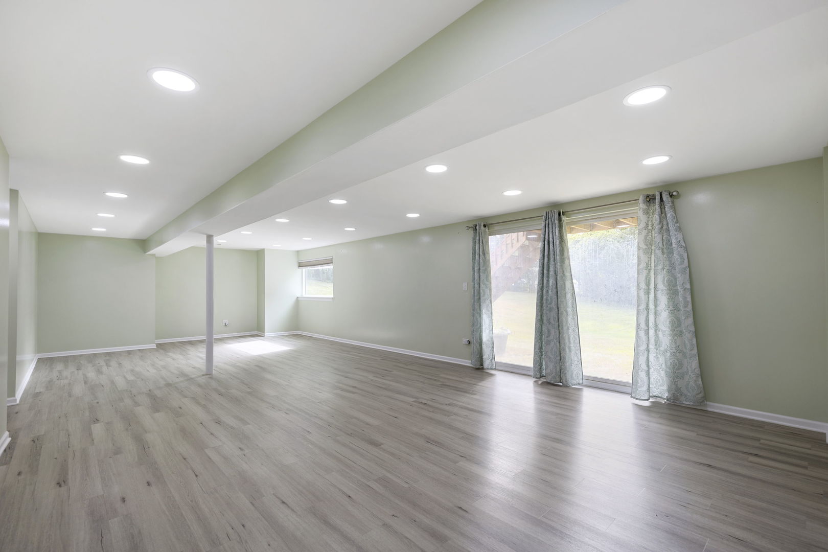 7623 Beringer Court Gurnee, IL 60031 - Photo 22 of 28 a view of an empty room with wooden floor and a window