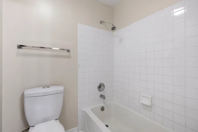 a bathroom with a toilet and shower