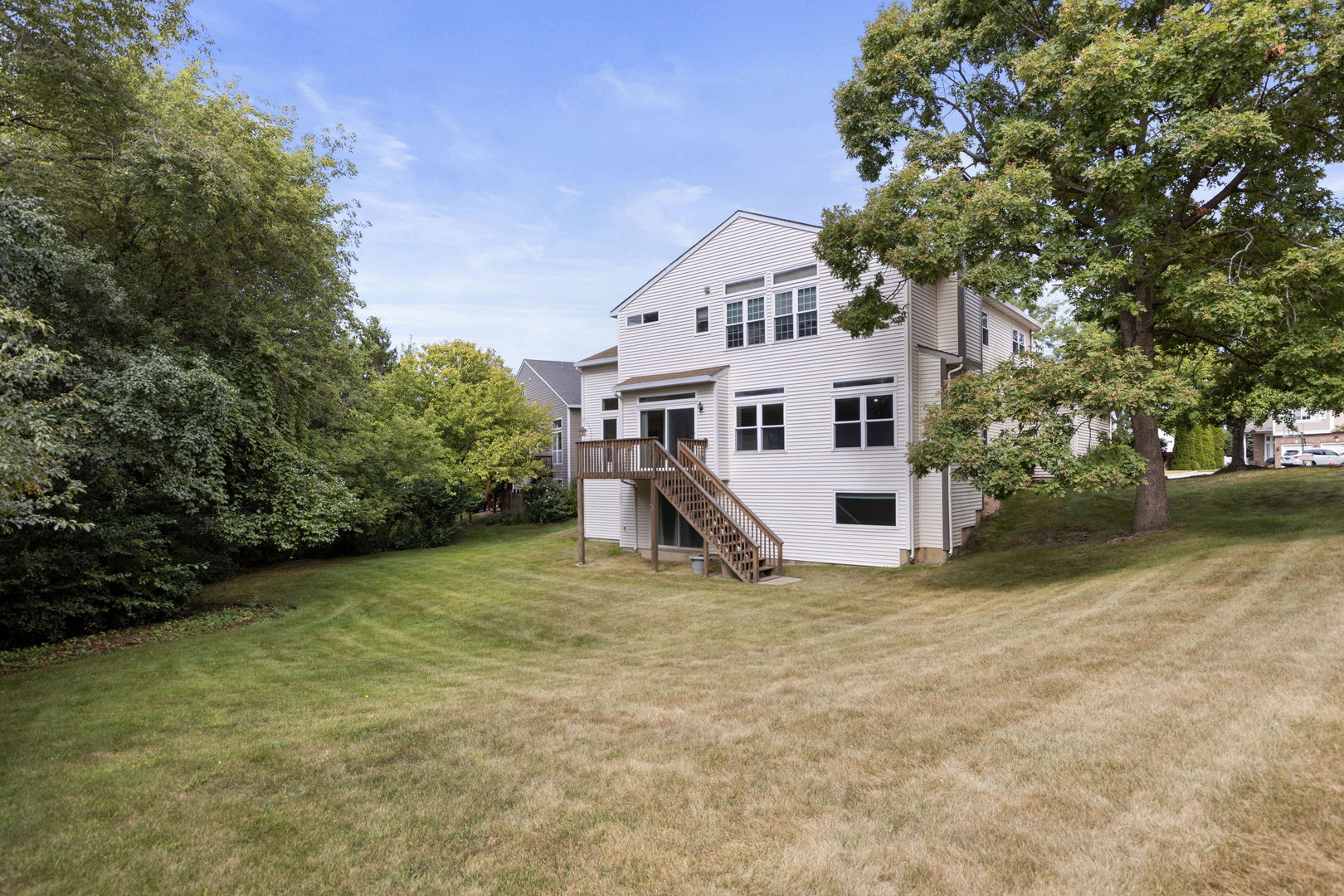 7623 Beringer Court Gurnee, IL 60031 - Photo 24 of 28 a view of a house with backyard and trees