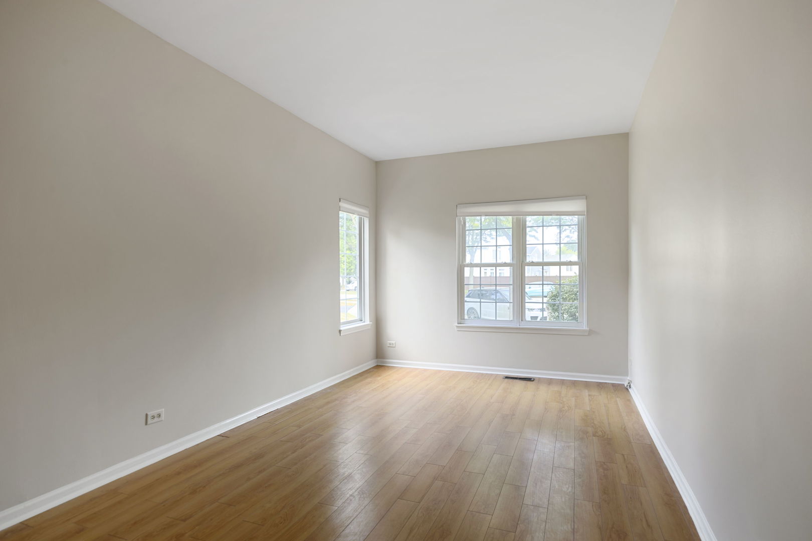 7623 Beringer Court Gurnee, IL 60031 - Photo 5 of 28 an empty room with wooden floor and windows