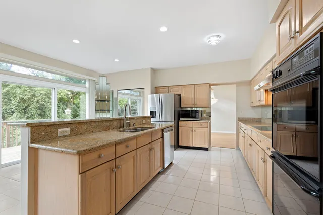 a kitchen with stainless steel appliances granite countertop a sink and a stove