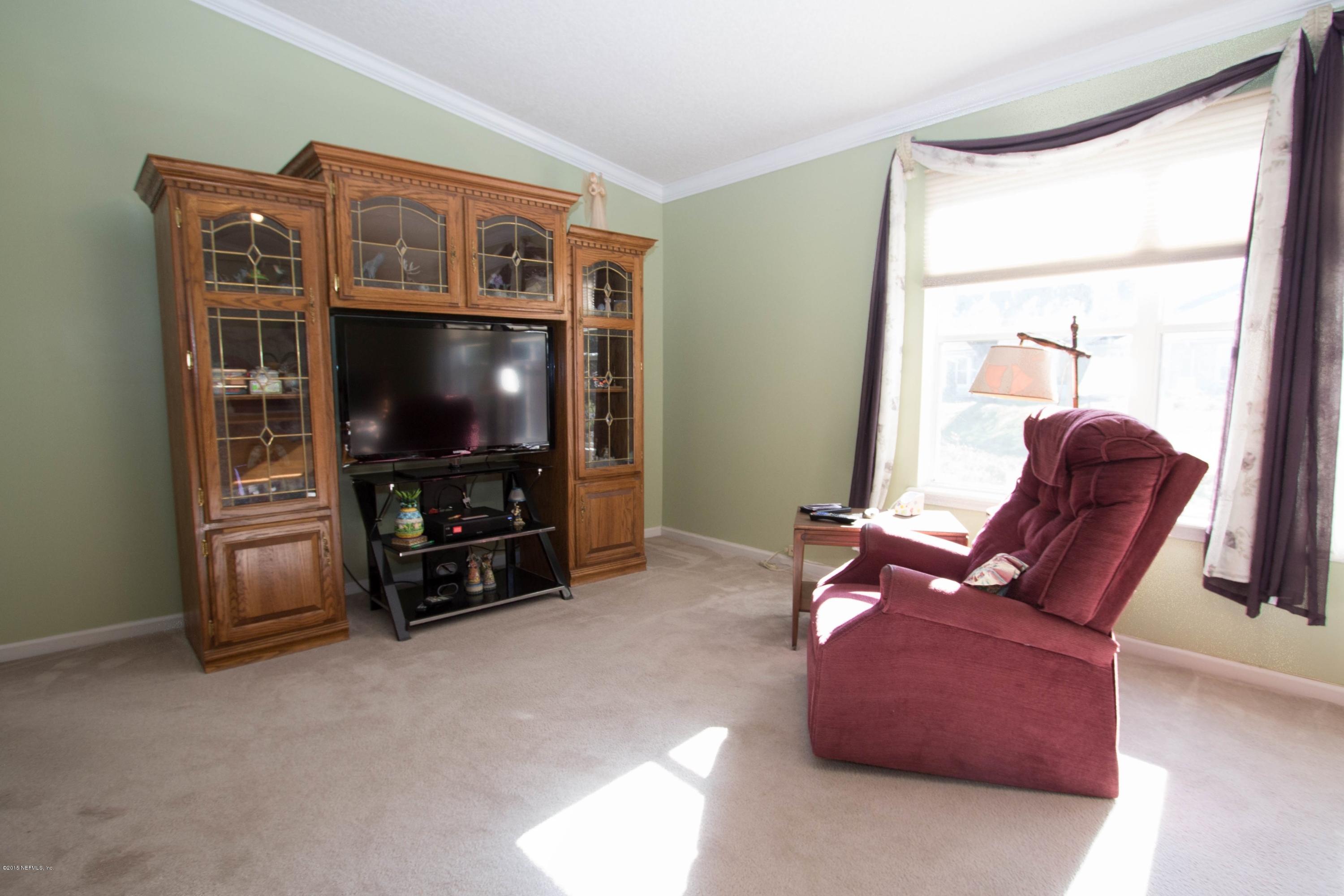 3140 Ravines Road Middleburg, FL 32068 - Photo 12 of 28 a living room with furniture and a flat screen tv