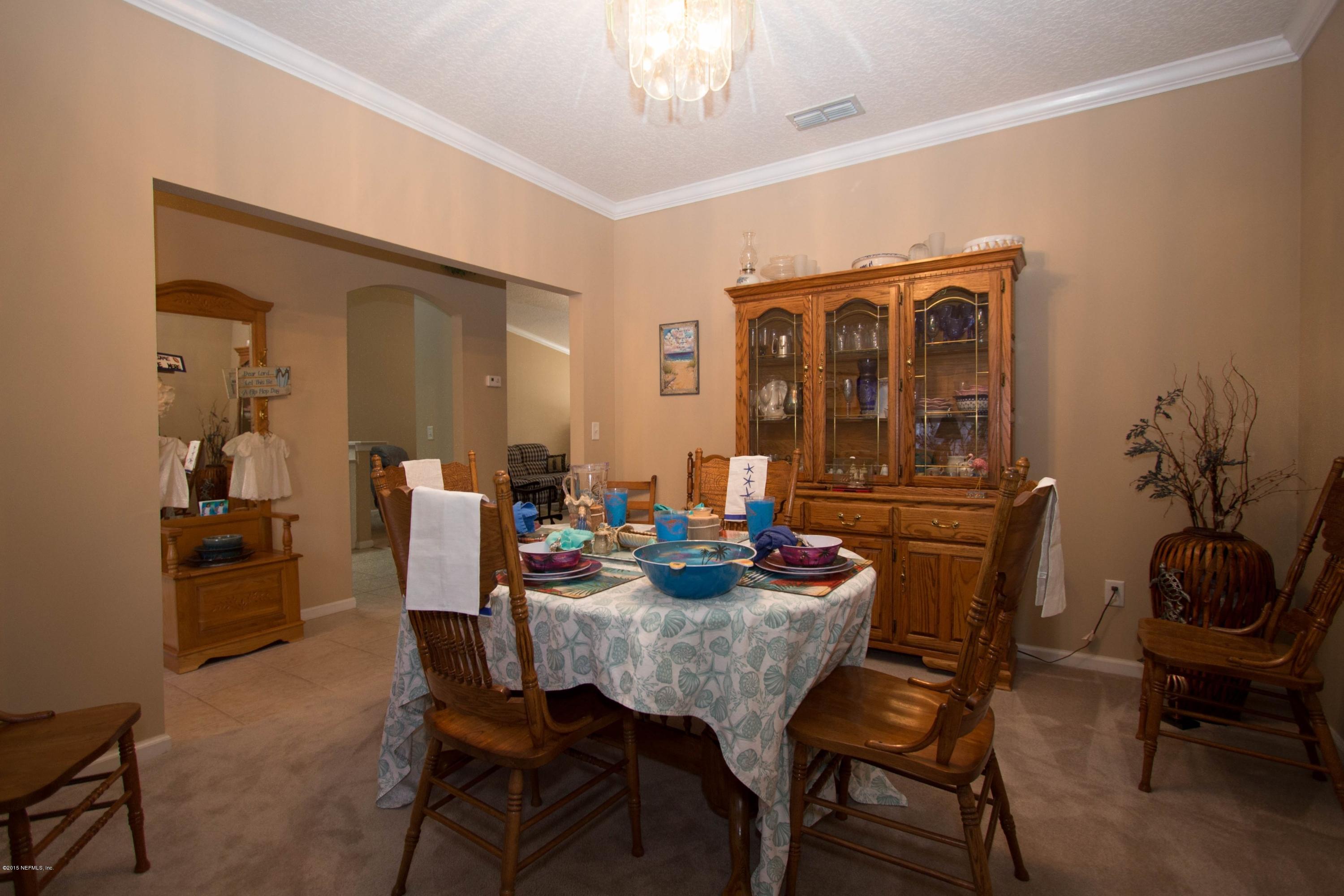 3140 Ravines Road Middleburg, FL 32068 - Photo 8 of 28 a view of a dining room with furniture and chandelier