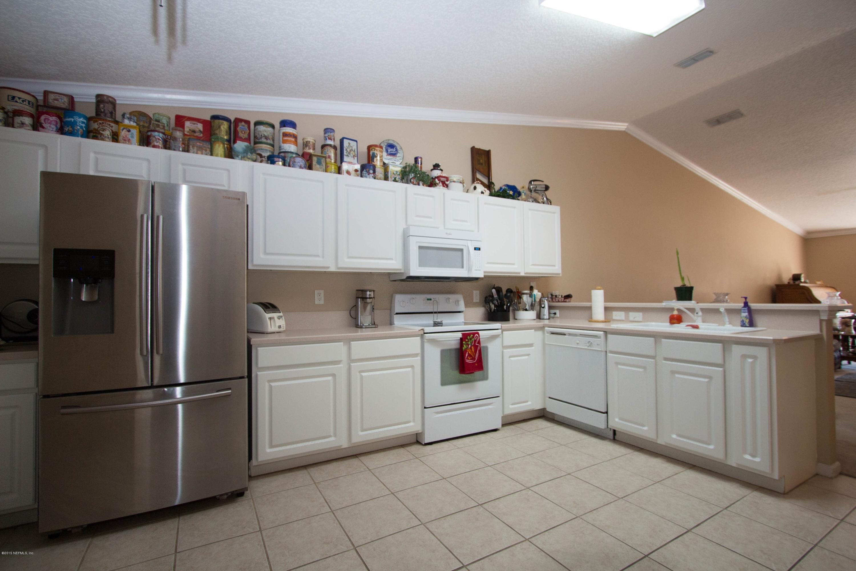 3140 Ravines Road Middleburg, FL 32068 - Photo 9 of 28 a kitchen with cabinets and stainless steel appliances