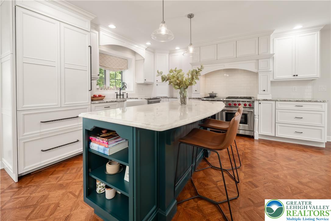 1588 Surrey Road Bethlehem, PA 18015 - Photo 12 of 50 a kitchen with stainless steel appliances granite countertop a sink a stove and a wooden floors