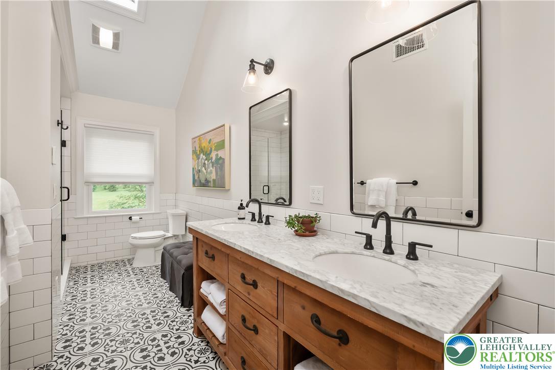 1588 Surrey Road Bethlehem, PA 18015 - Photo 35 of 50 a bathroom with a granite countertop sink a toilet and a mirror
