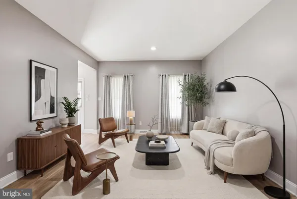 a kitchen with stainless steel appliances granite countertop a refrigerator a sink dishwasher a stove and white cabinets with wooden floor