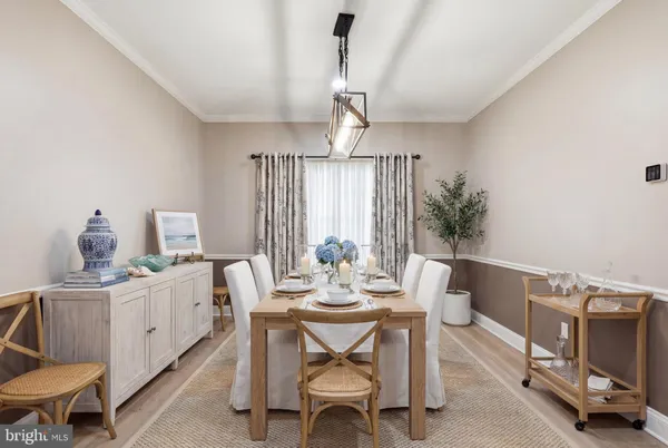 a view of a room with a chandelier and wooden floor