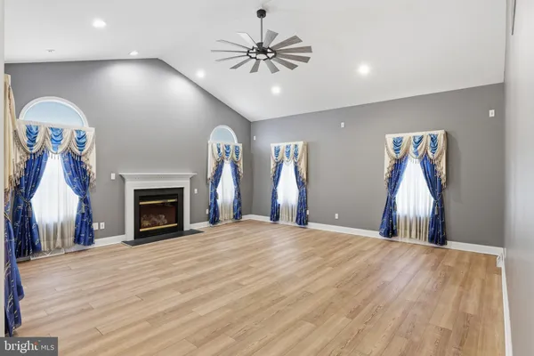 an empty room with closet and a chandelier fan