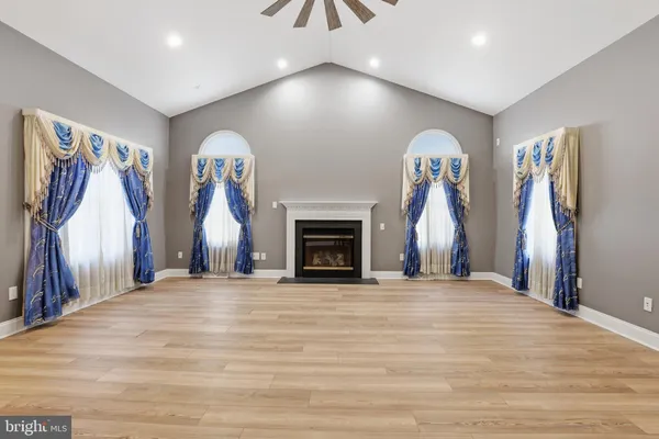an empty room with wooden floor and a window