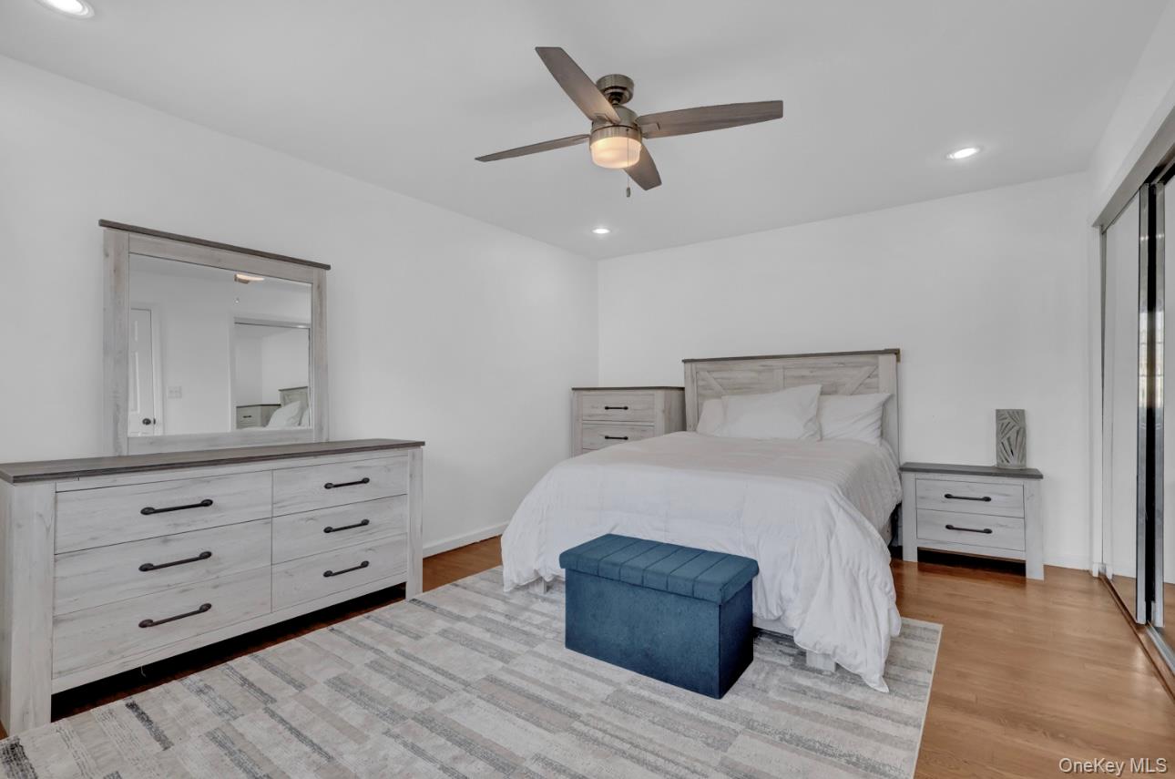 83 Finch Lane, Unit 2B Islip, NY 11751 - Photo 11 of 18 a bedroom with a bed and a dresser