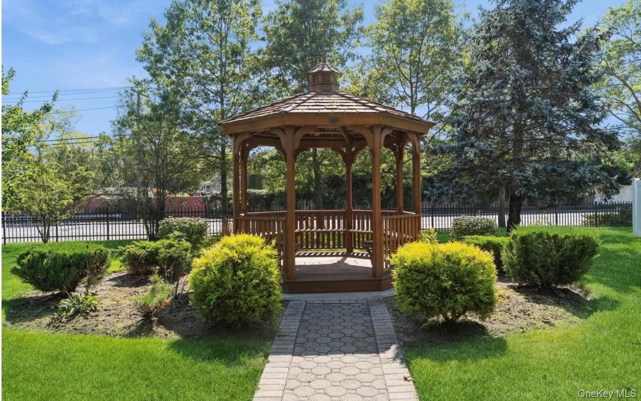 83 Finch Lane, Unit 2B Islip, NY 11751 - Photo 15 of 18 a view of a bench in the garden