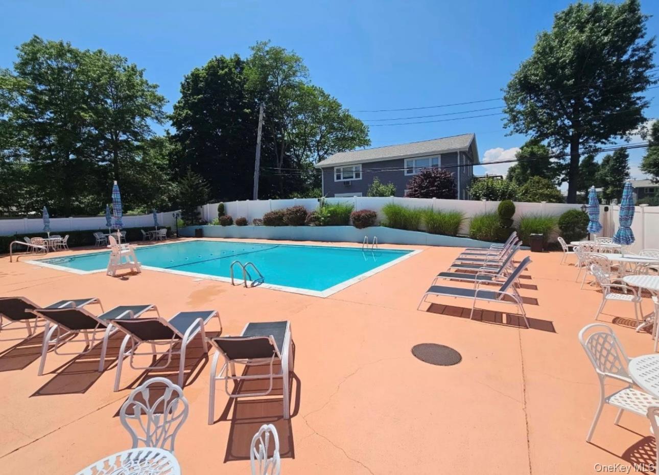 83 Finch Lane, Unit 2B Islip, NY 11751 - Photo 16 of 18 a view of outdoor space yard swimming pool and patio