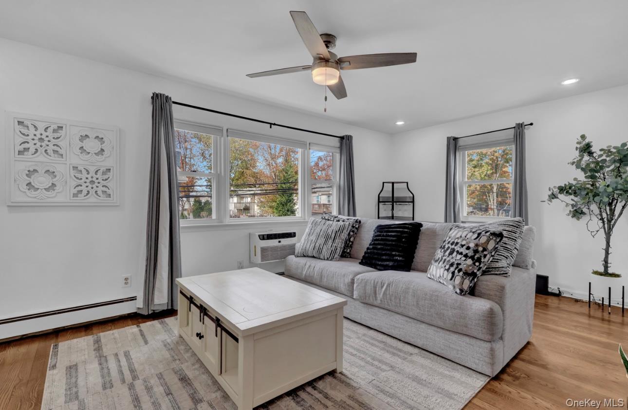 83 Finch Lane, Unit 2B Islip, NY 11751 - Photo 5 of 18 a living room with furniture and a large window