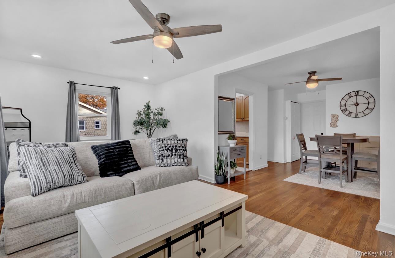 83 Finch Lane, Unit 2B Islip, NY 11751 - Photo 6 of 18 a living room with furniture and wooden floor