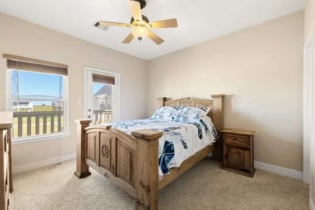 a spacious bedroom with a bed and wooden floor