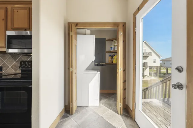 a bedroom with a bed next to a window and a chandelier