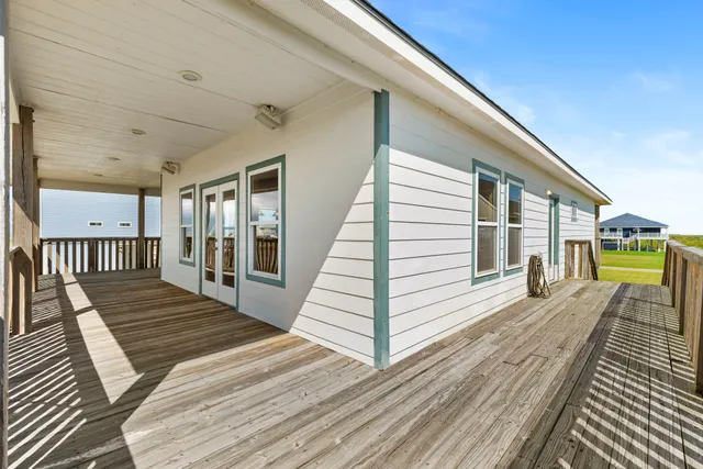 a view of a balcony with wooden floor and outdoor space