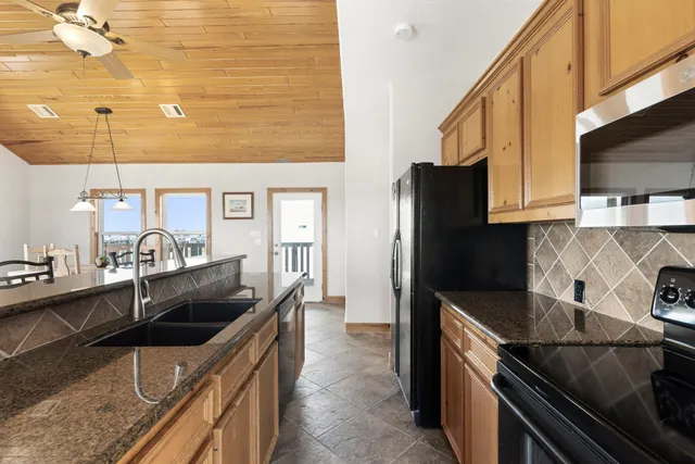 a living room with furniture a flat screen tv and a table