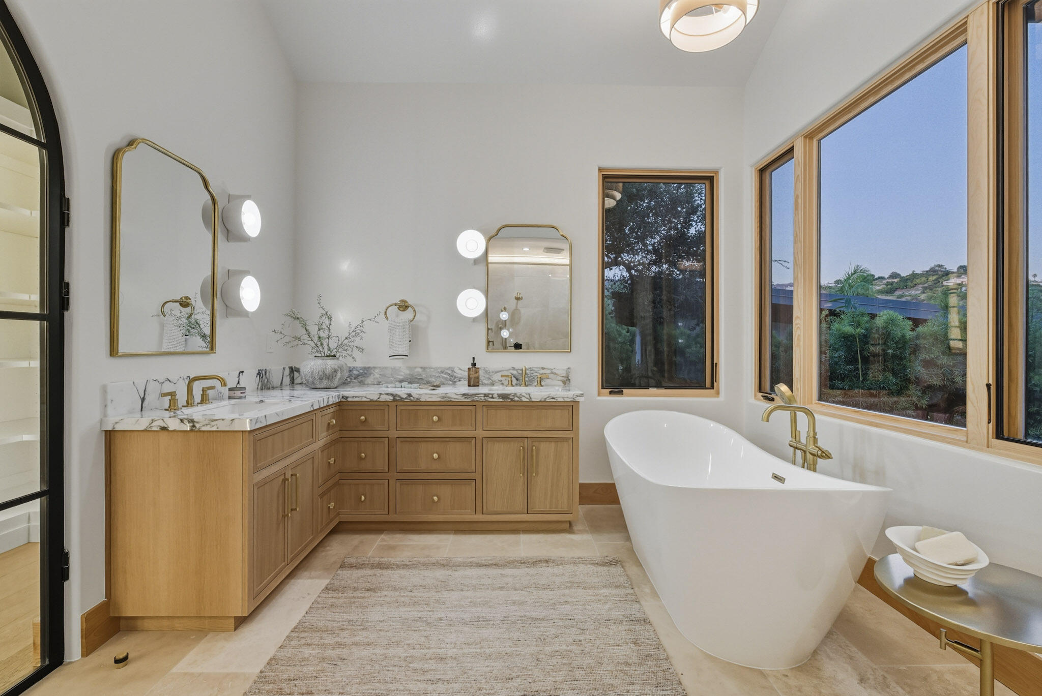 210 Las Alturas Road Santa Barbara, CA 93103 - Photo 28 of 61 a large tub sitting next to a bathroom sink and a large mirror