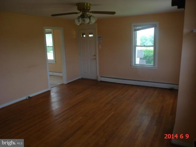 12301 Warner Road Keymar, MD 21757 - Photo 10 of 16 an empty room with wooden floor and windows