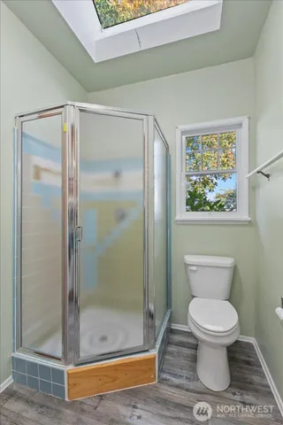 a bathroom with a toilet and a shower