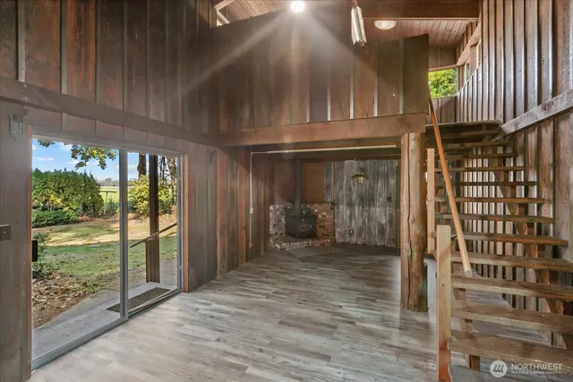 a view of front door with wooden floor and stairs