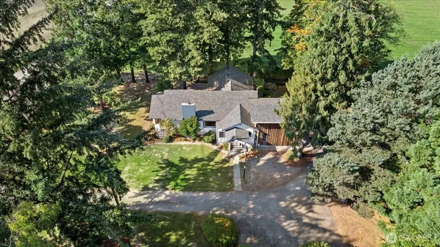an aerial view of a house with a yard