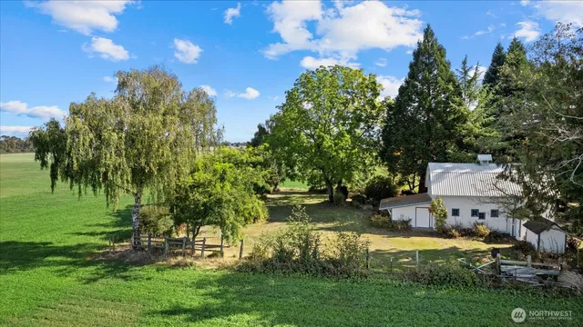 a backyard of a house with a garden and outdoor seating