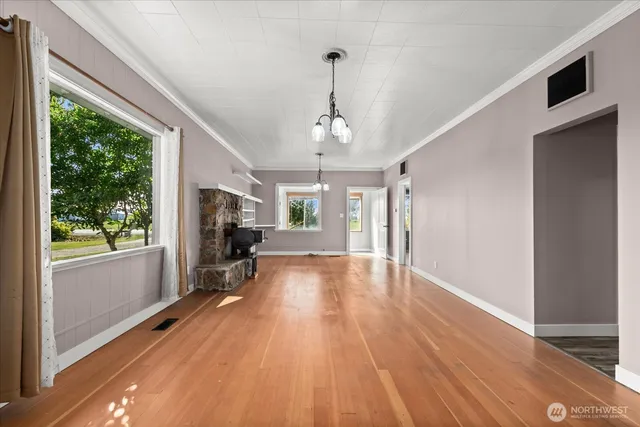 a very nice looking room with wooden floor and a window