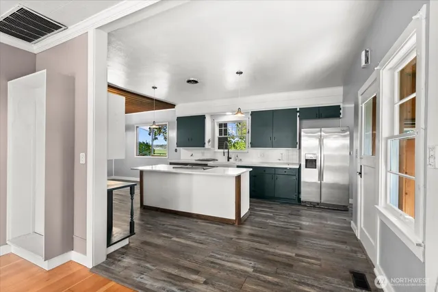 a kitchen with a sink cabinets and stainless steel appliances