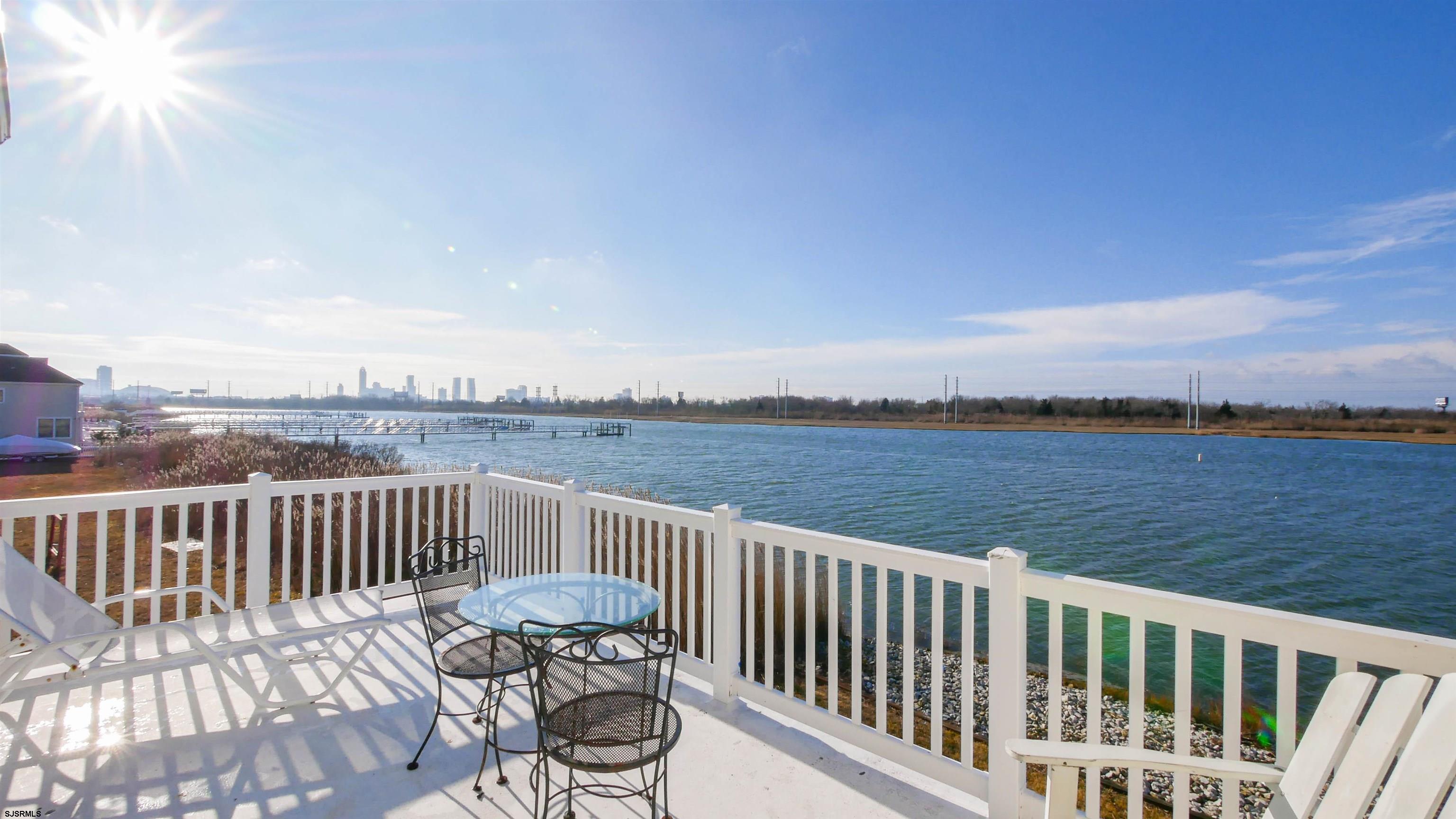 2070 West Riverside Drive Atlantic City, NJ 08401 - Photo 19 of 40 a view of a roof deck with two chairs and wooden floor