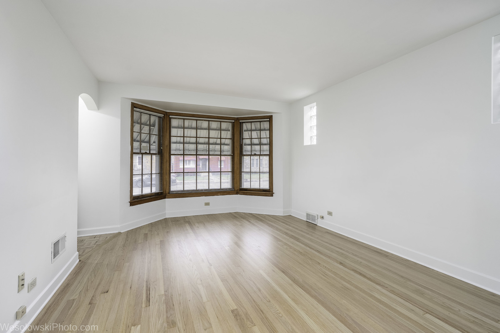 5944 West Foster Avenue Chicago, IL 60630 - Photo 3 of 21 an empty room with wooden floor and windows