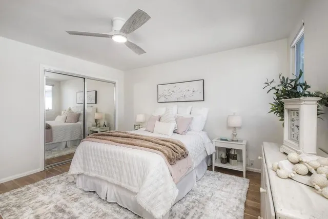 a spacious bedroom with a bed and a chandelier