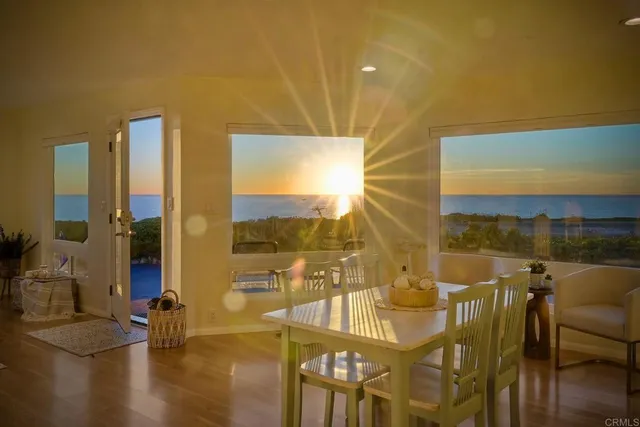 a view of a balcony with dining table and chairs