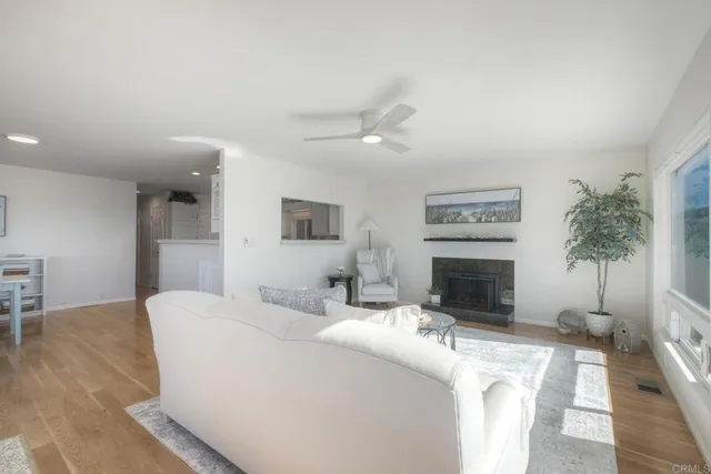 a living room with furniture a dining table and a flat screen tv