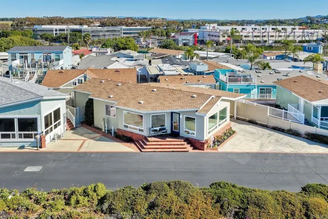 an aerial view of a houses with street
